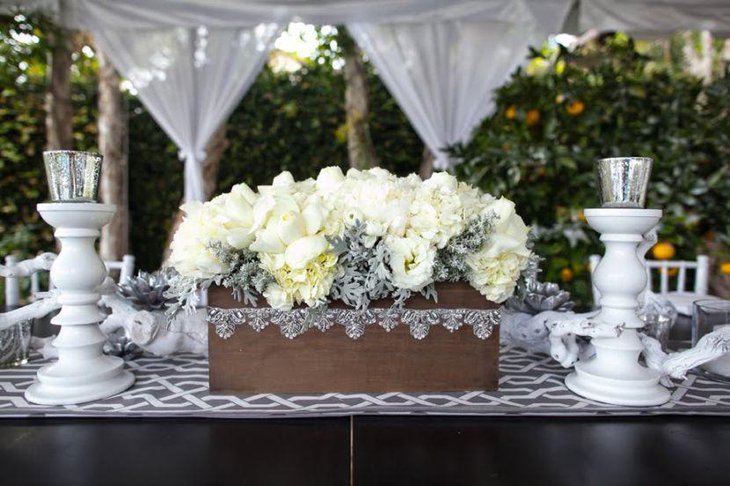 White and silver candle holders and roses for party table decor