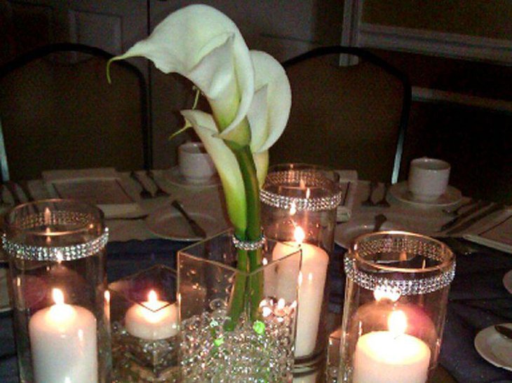 White candles in bling holder centerpieces for wedding tables