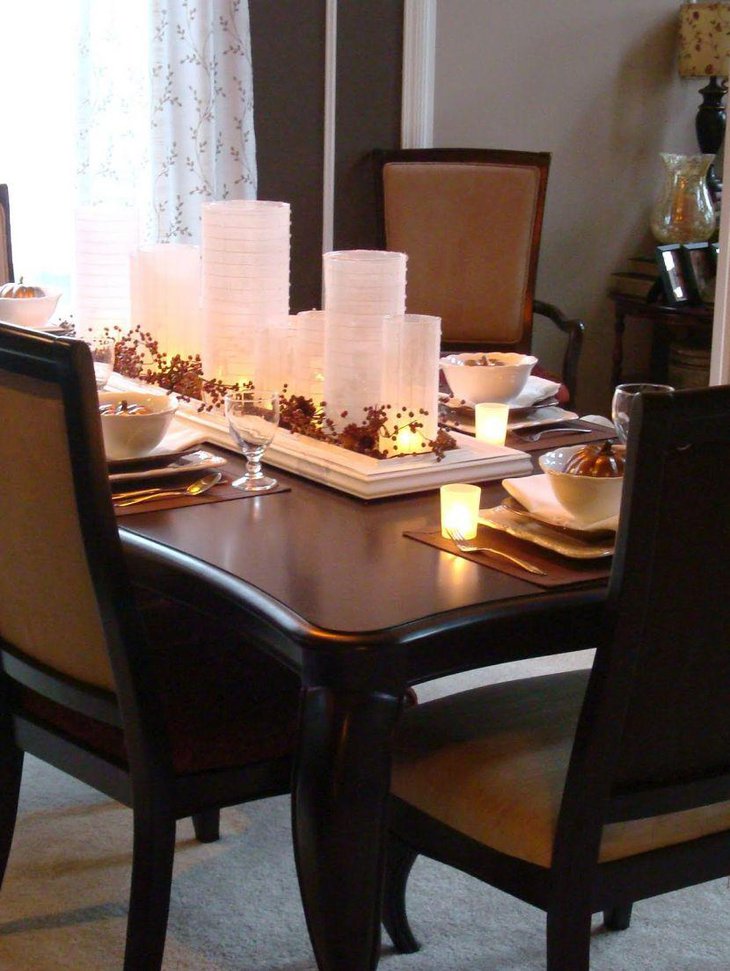 White lanterns lit up with candles add a shimmering touch to this breakfast table