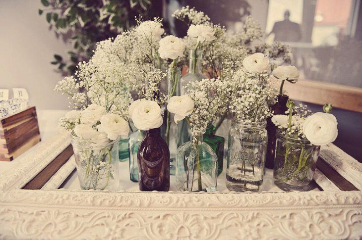 White vintage wedding table decor with flowers