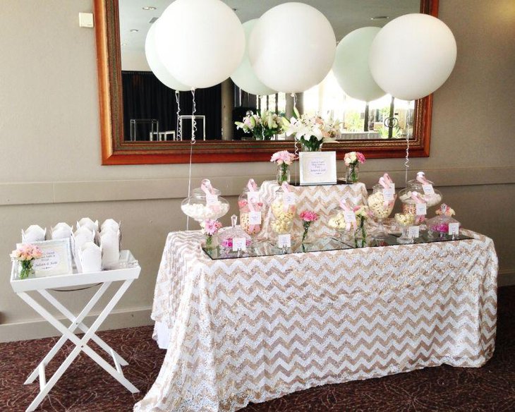 White wedding candy table decor with pink accents