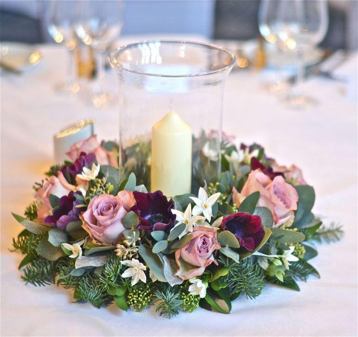 Winter table decor with wintery foliage and candle jar