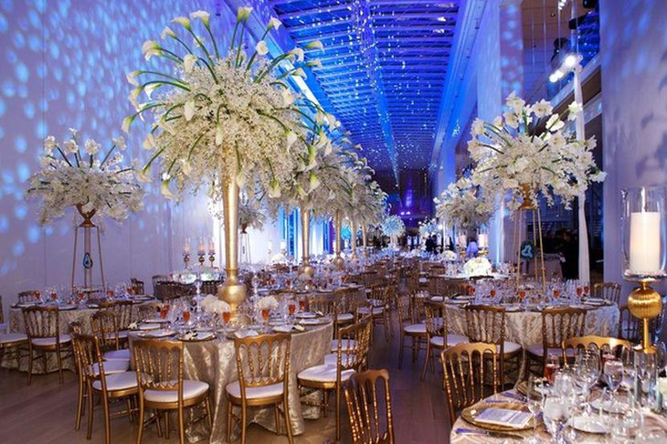 Winter wedding table decor with tall golden floral vases