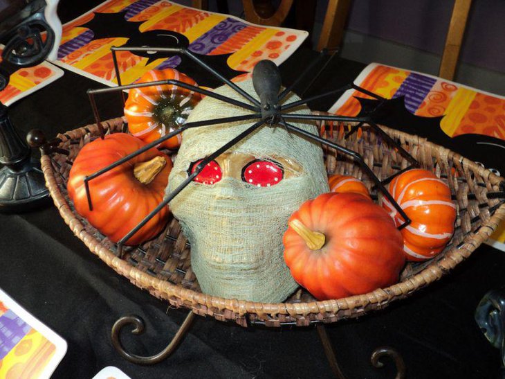 Wrapped skull with a black spider on top Halloween table centerpiece
