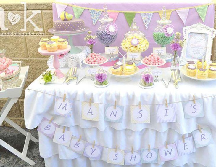 Yellow purple and green candy display on baby shower candy table