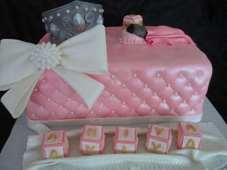 A baby shower cake for a little princess with a cute bow