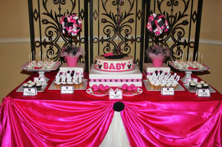 A baby shower cake with Minnie Mouse as its theme