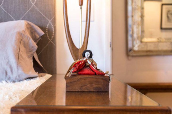 A red figurine of a woman at the base of the lamp looks stunning