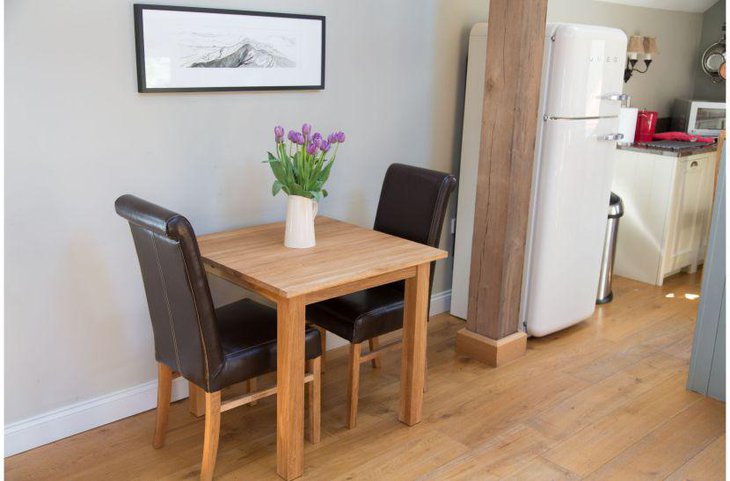 A small kitchen breakfast table decorated with flowers