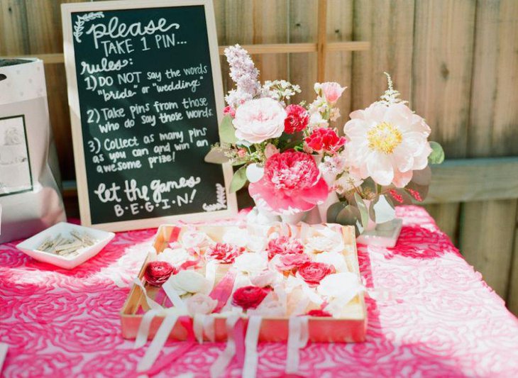 Adorable pink flowers and tablecloth decor on a bridal shower table