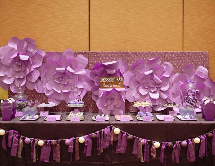 Amazing purple flower decoration on bridal shower dessert table