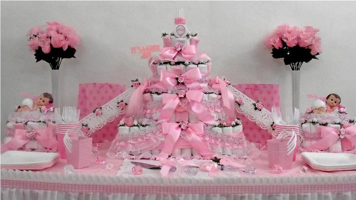 An elaborate baby diaper cake announcing the arrival of a girl