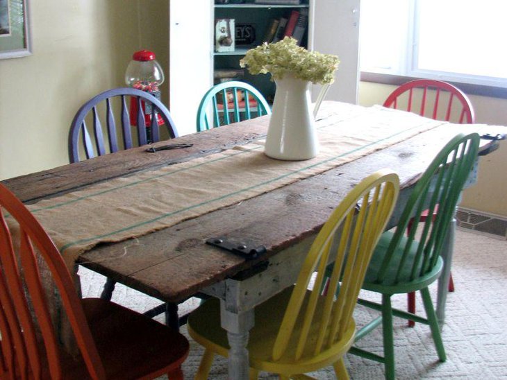 An old barn door has been used as a DIY dining room table