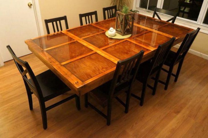 An old garage door has been converted into a DIY dining table