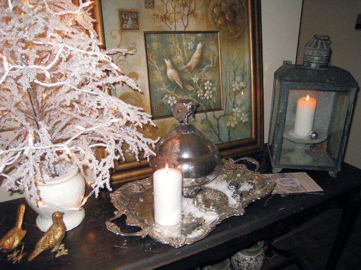 An old silver tray vignette with golden birds and candle