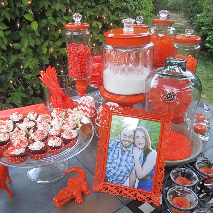 An orange themed garden bridal candy table