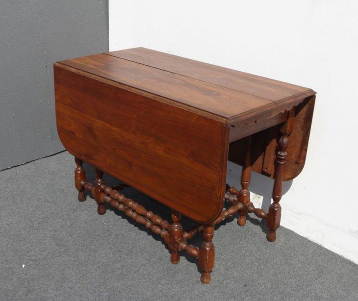 Antique drop leaf dining table made of walnut