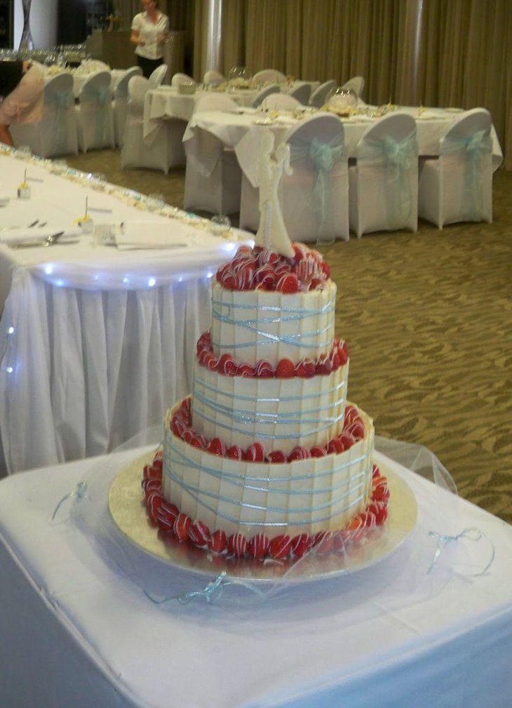 Aqua blue ribbon decoration on white wedding cake