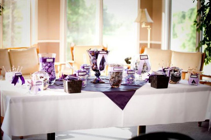 Astonishing purple and white accented wedding candy table