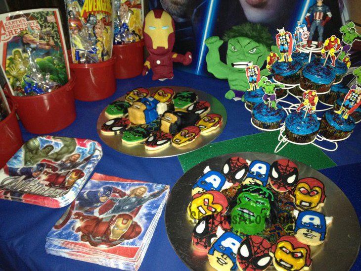 Avengers cookies and candy packets seen displayed on this kids birthday sweets table