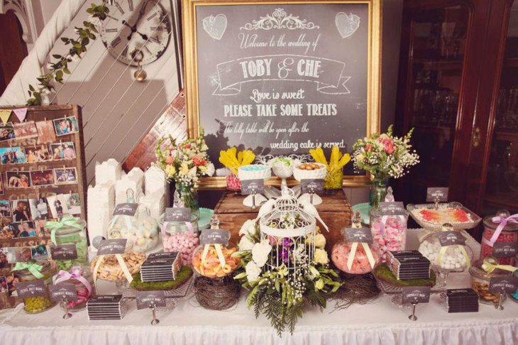 Awesome DIY wedding candy table setting with floral arrangements
