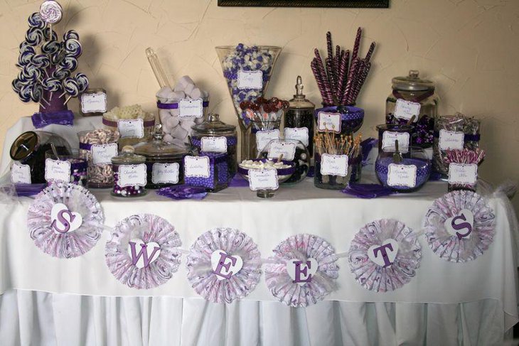 Awesome purple and white wedding candy table