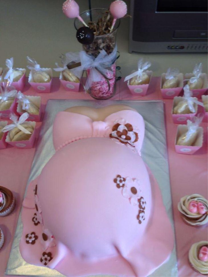 Baby shower cake with a cute pink baby bump
