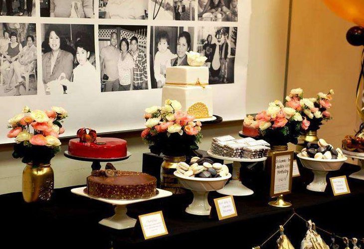 Beautiful 60th birthday table decor with golden motif at the base of the cake and golden vases