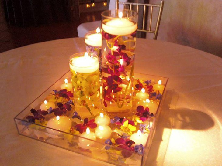 Beautiful glass jar floating candle centerpiece for wedding table