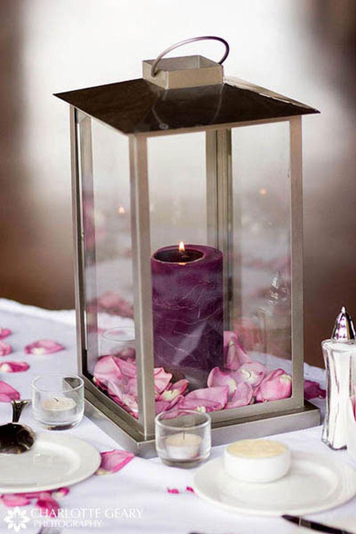 Beautiful lantern with purple candle wedding table centerpiece