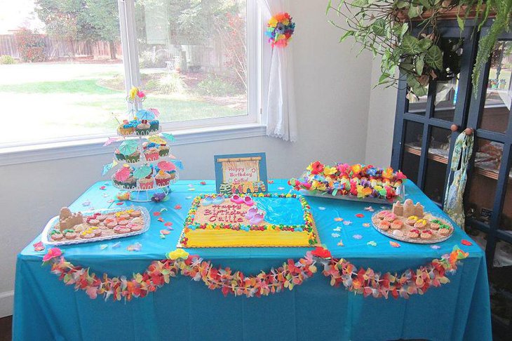 Beautiful pink and blue umbrella decorations on summer birthday table