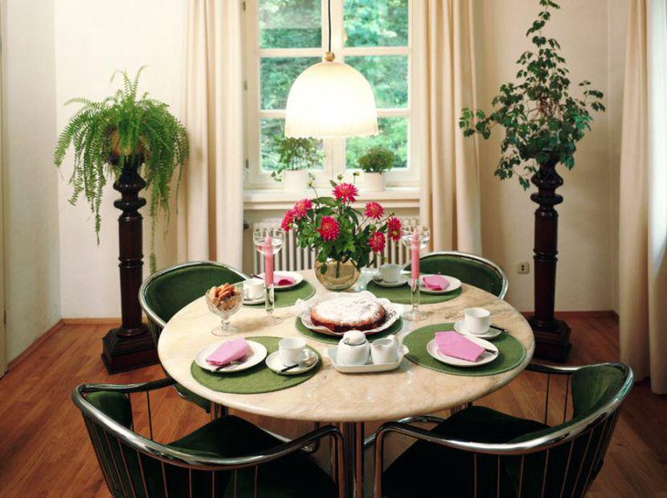 Beautiful red floral centerpiece adds a charming touch to this breakfast table