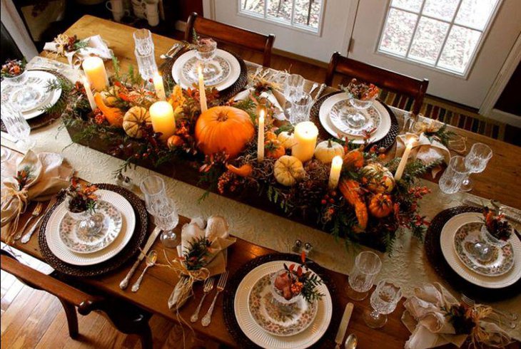 Beautiful Thanksgiving tablescape with autumn seasonal fruit and flower decorations