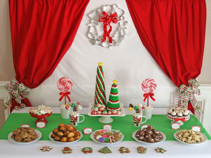 Big candy canes with red bows on kids Christmas dessert table