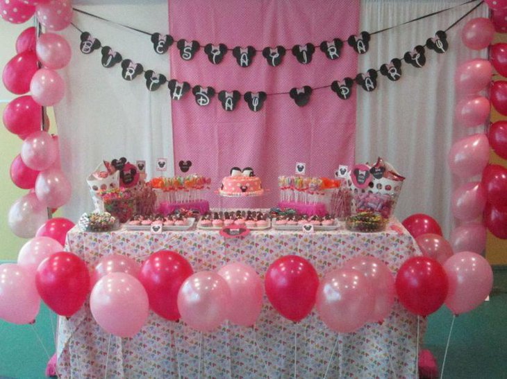 Birthday party candy buffet table themed on Minnie Mouse