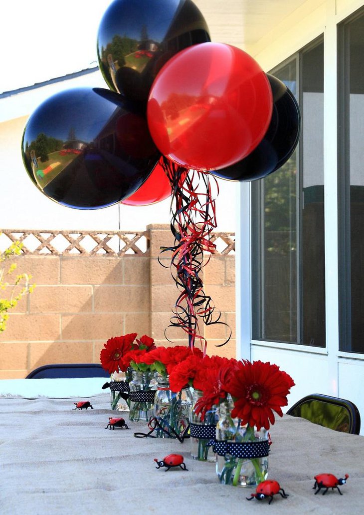 Черные воздушные шары и красные цветы