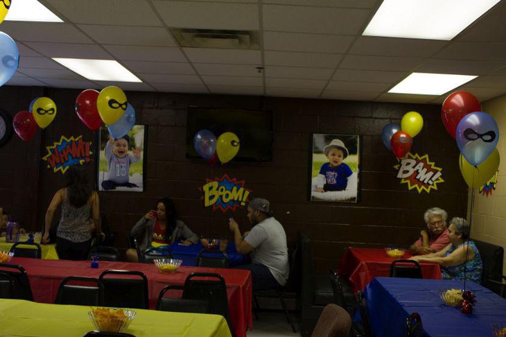 Boys first birthday guest table decor with super hero balloon centerpieces