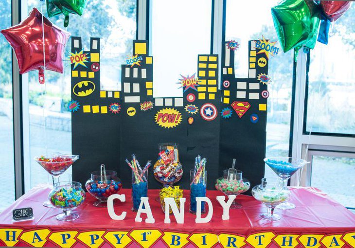 Candy table decor with super hero theme for first birthday