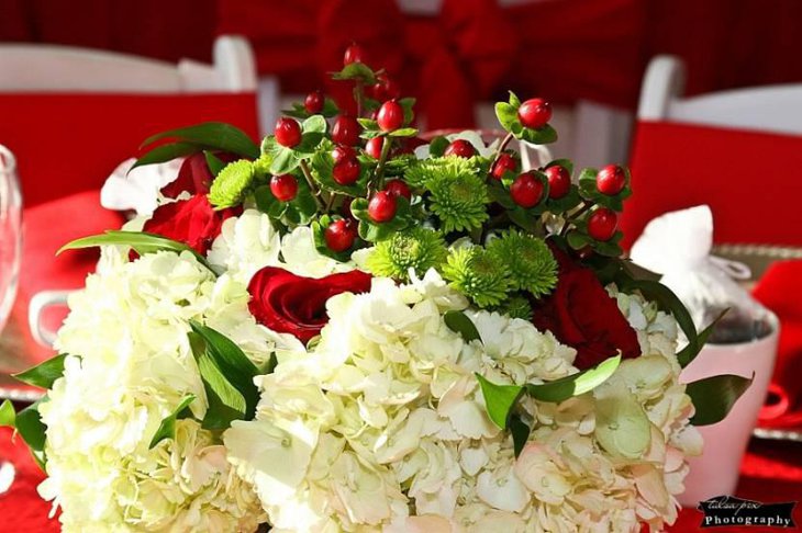 Centerpieces of White Hydrangea Red Hypericum Berries and Roses