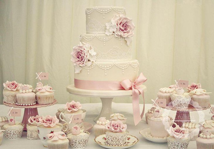 Charming pink and white themed decor on European dessert table