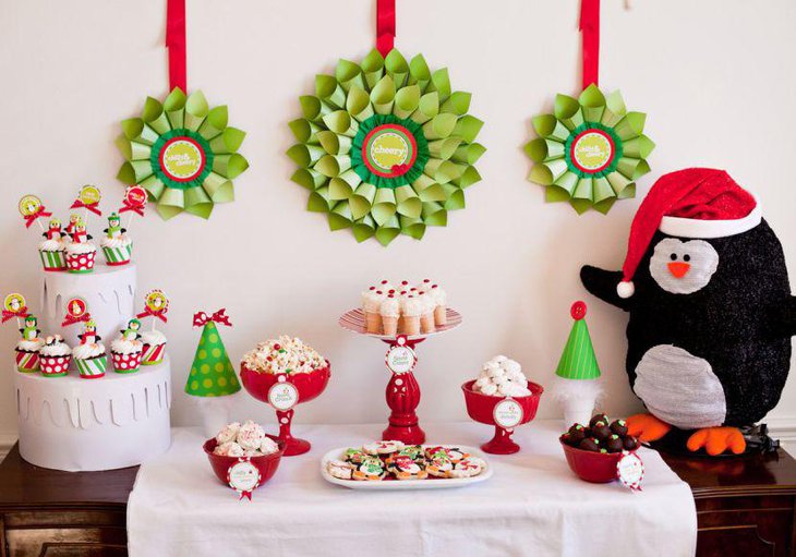 Cheery kids Christmas dessert table decor with penguins