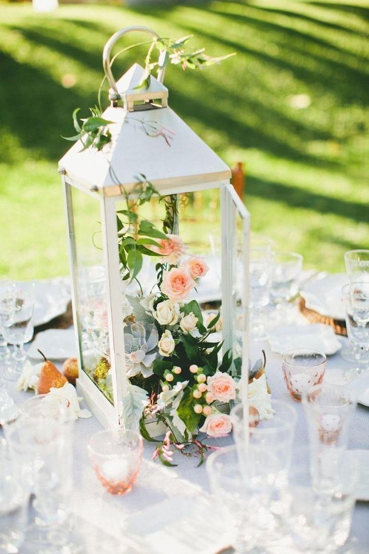Chic lantern centerpiece with blooms on garden party table