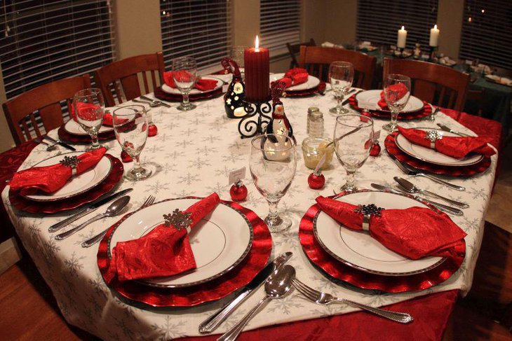 Christmas Table Decor With Red Napkins Tablecloth and Silver Napkin Holders Plus Silver Rimmed Plates