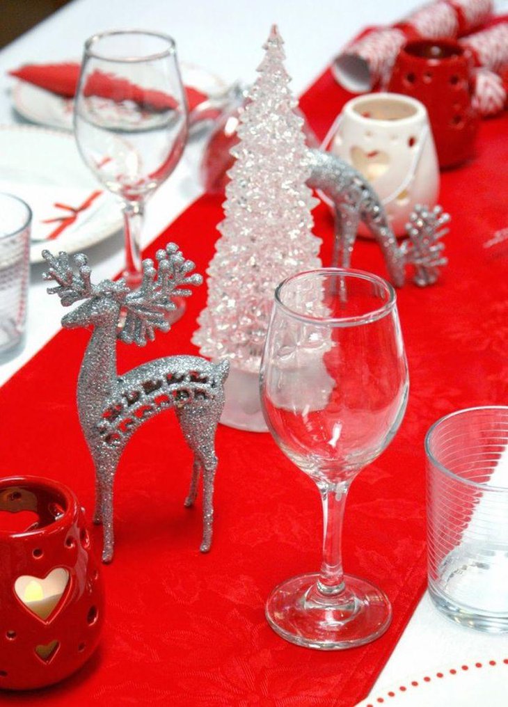 Christmas Table Decor With Silver Reindeer Figurines and Red Vases