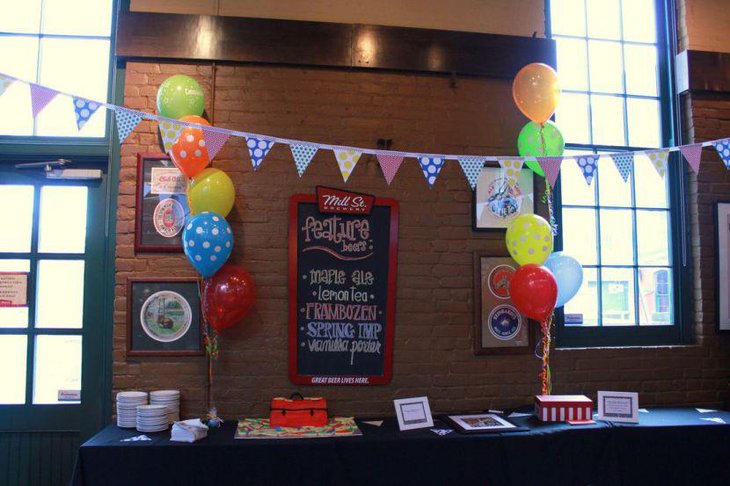 Colourful balloon centerpieces on retirement party table