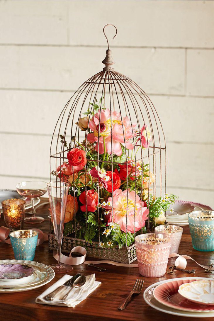 Colourful floral birdcage centerpiece