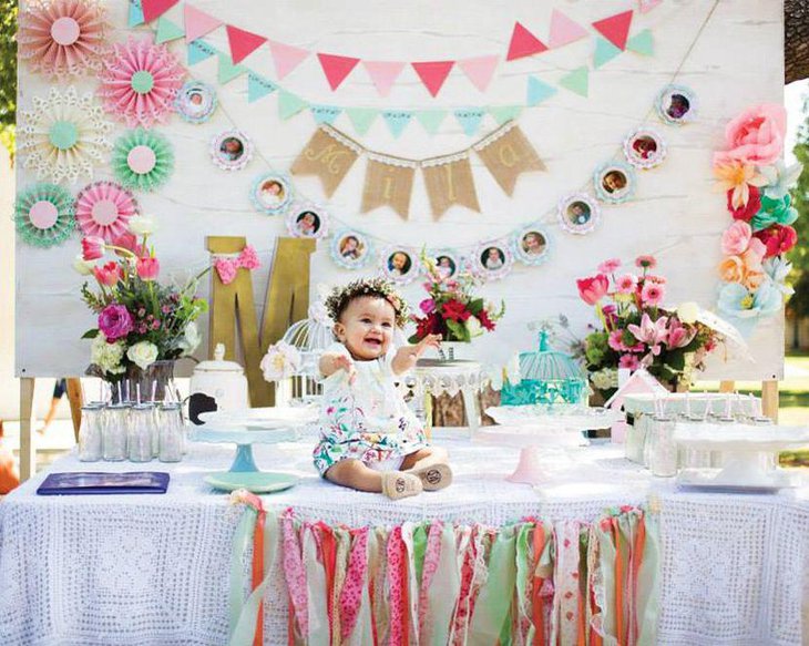 Colourful floral display on a first birthday spring table