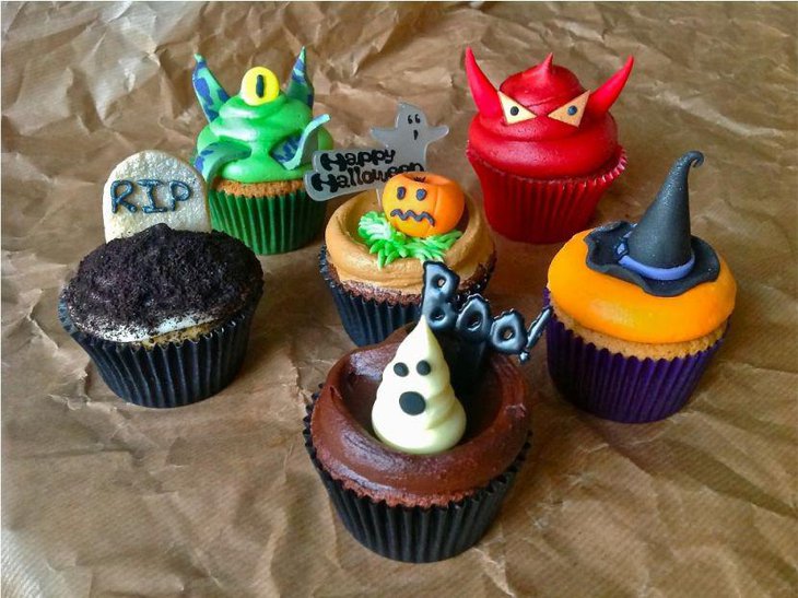 Colourful monster cupcake decorations on kids Halloween table