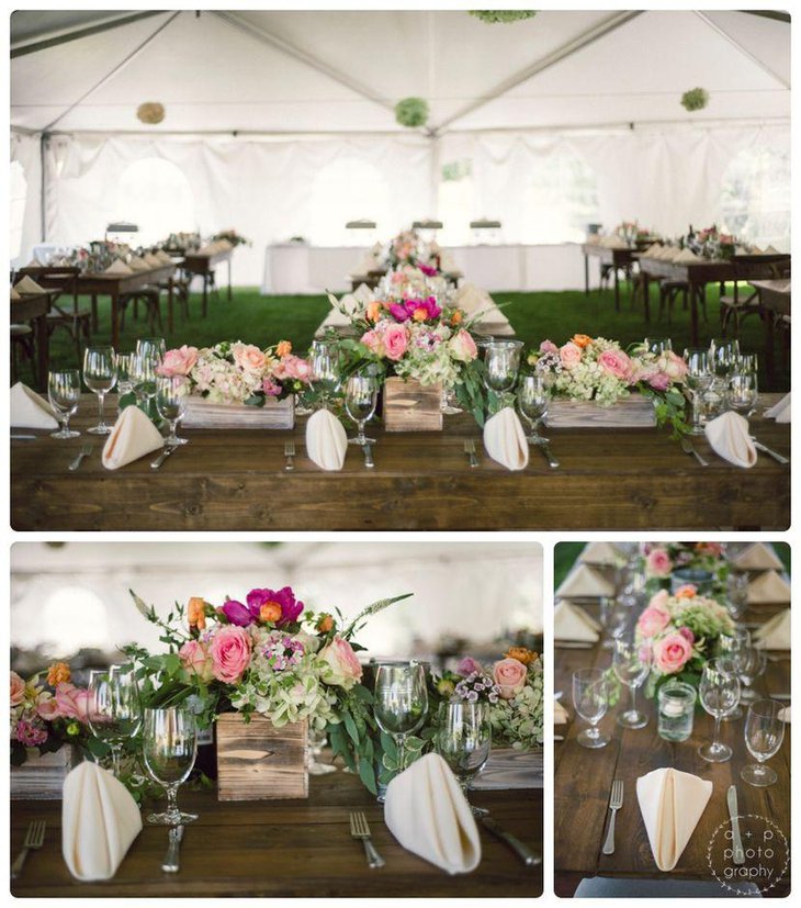 Country wedding reception tables decked up with wooden box centerpieces