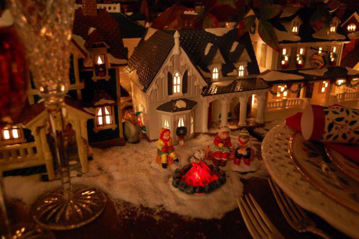 Creative lit up house decoration on christmas table